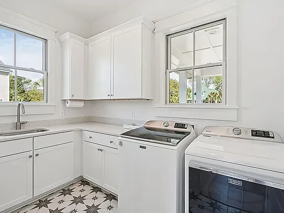 Large laundry room with cabinets and sink