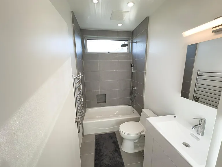 The upstairs tiled bathroom shared by the two non-Master bedrooms.