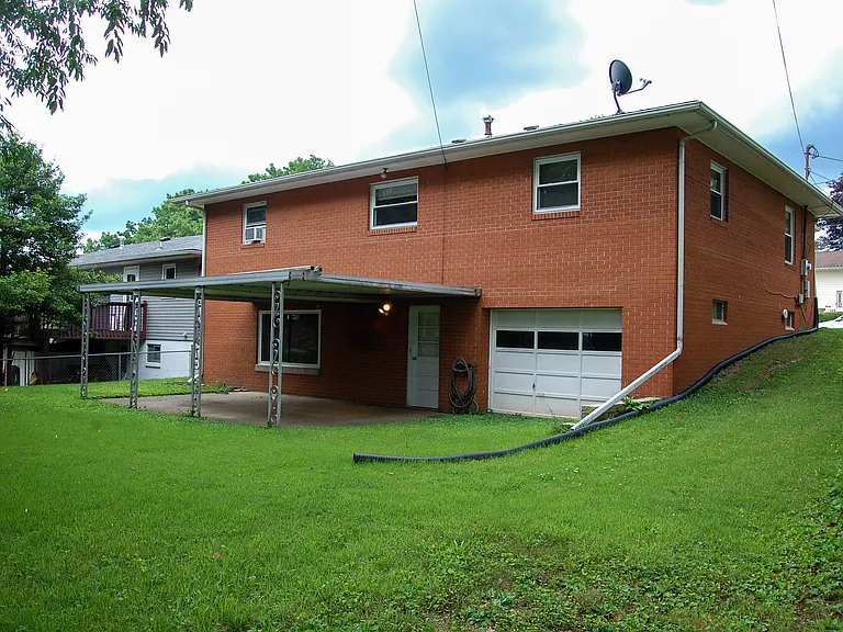 Back of house, featuring a 2-car garage and covered porch