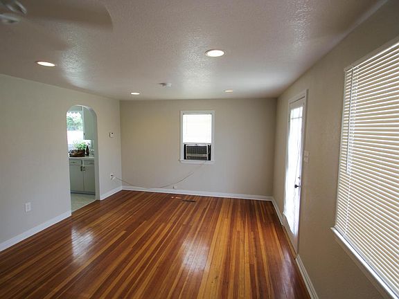 Living Room, South wall: kitchen entry, front door, and picture window