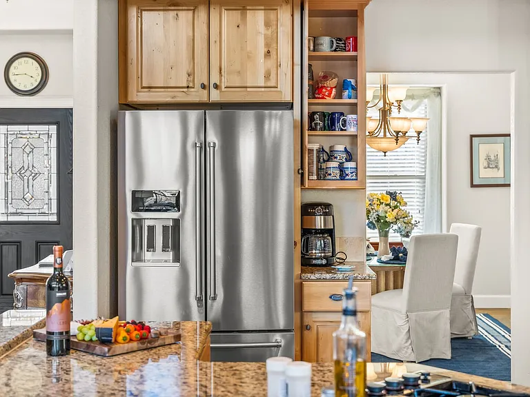 Top of the line kitchen with stainless steel appliances and granite countertops.