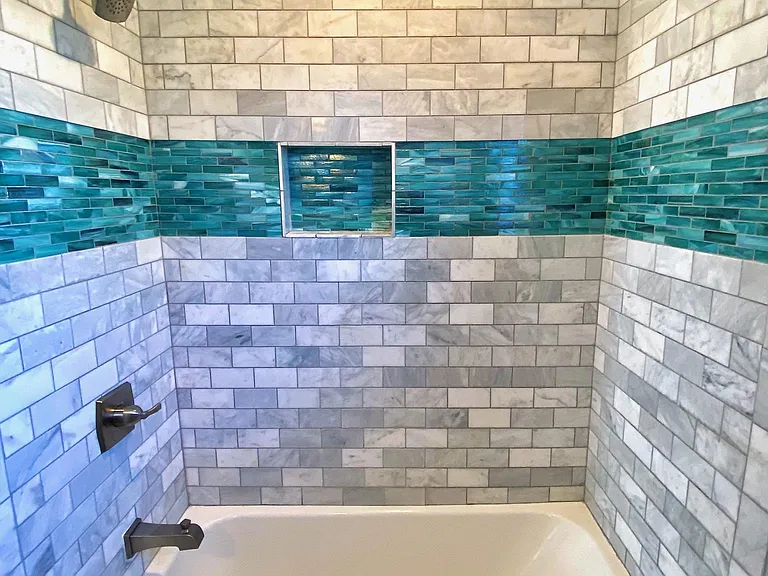 Freshly renovated shower tile and fixtures