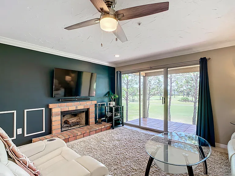 65" wall-mounted smart TV with sound-bar.
