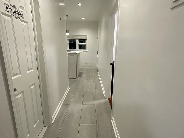 Hallway to Bathroom (left), Bedroom #3, and Kitchen