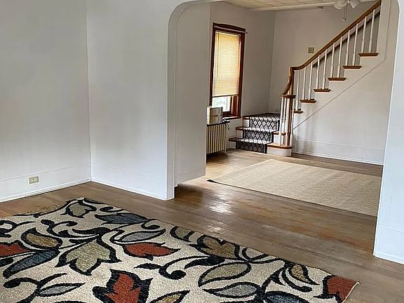 living room looking from front door toward the formal dining room and stairs to the second floor