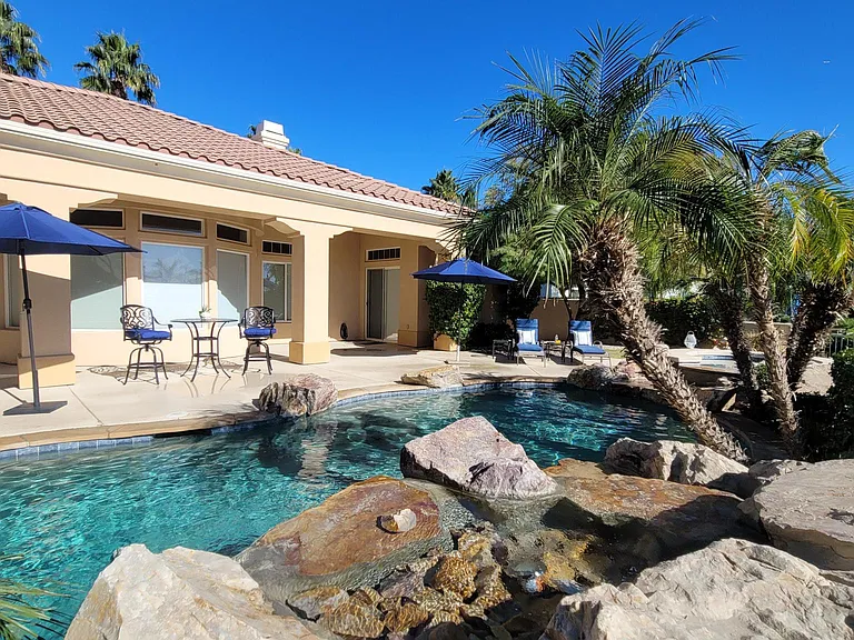 Large patio with 3 umbrellas, lounge chairs, dining table, BBQ, scenic views spectacular property!