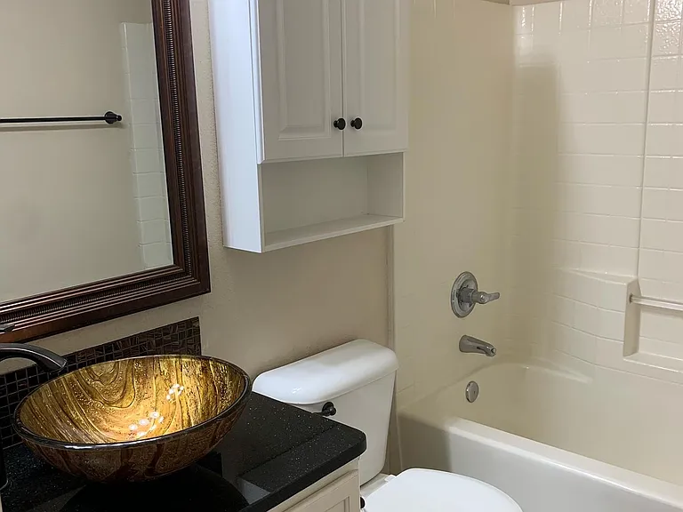 Guest bathroom with granite countertop and basin sink.