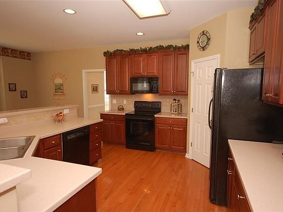  Beautiful Maple cabinets, tile back splash and Corian countertops.