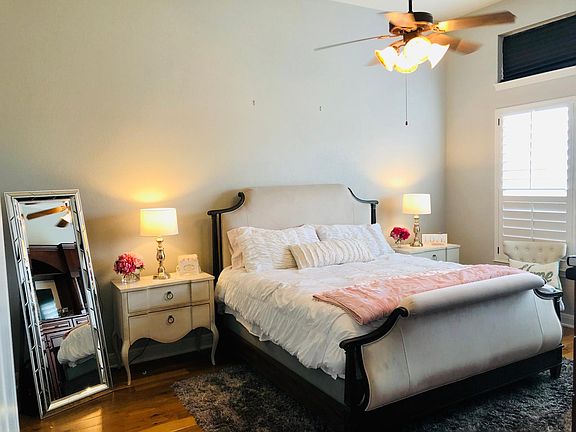 Master bedroom includes an oversized built in armoire/tv stand located in front of bed.