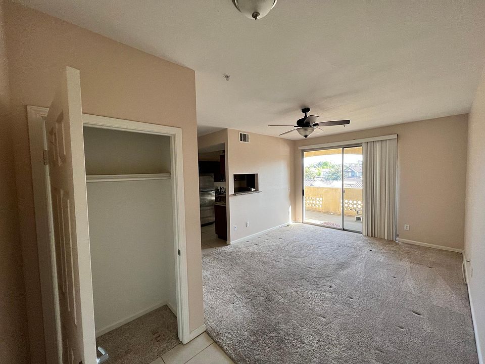 Entryway with storage closet, living room, access to balcony.