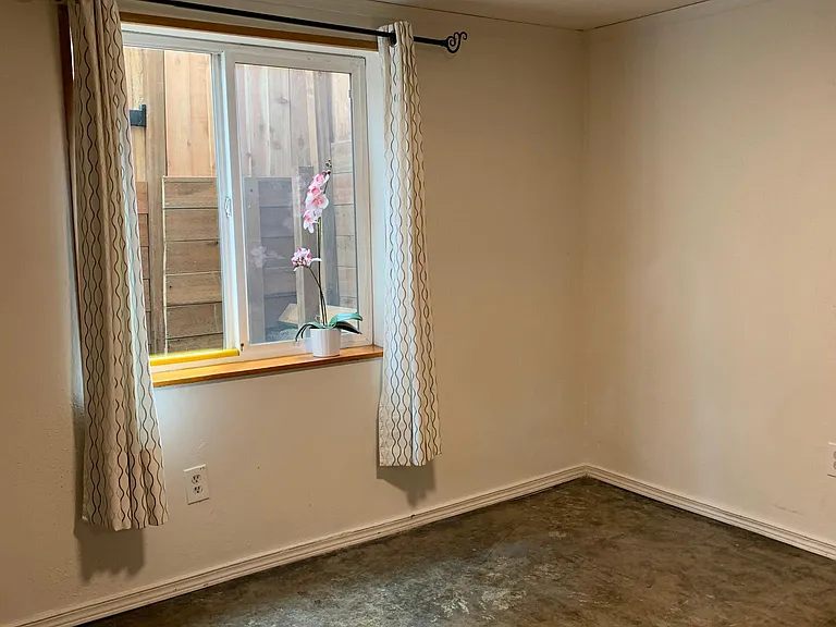 BEDROOM LOOKING OUT 4X5' WINDOW ONTO SOUTHEND PATIO