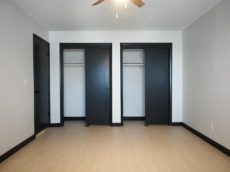 Two closets in a bedroom.