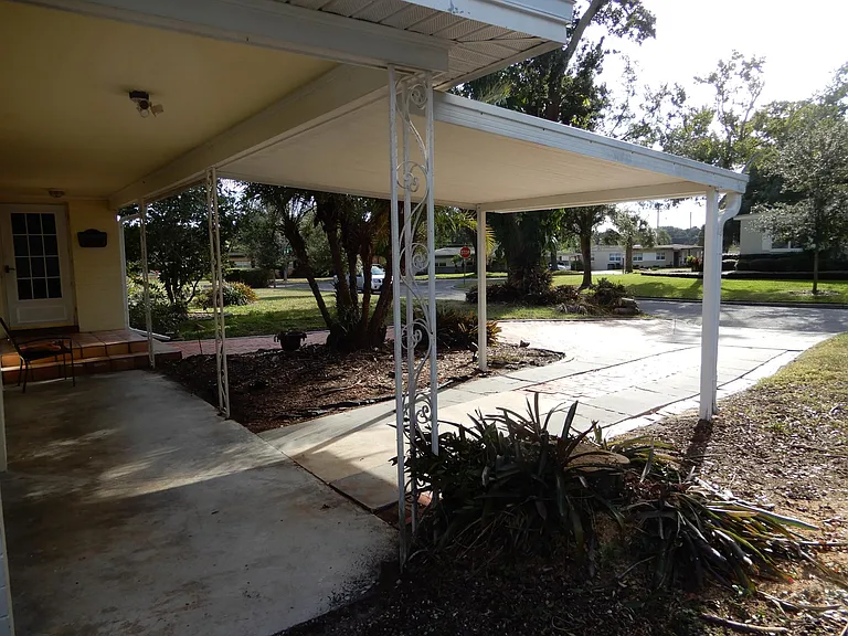 Single car garage with garage door opener (NOT SHOWN) and additional covered carport covering for another car. Helps keep your vehicle cool and out of the sun and rain during the summer.
