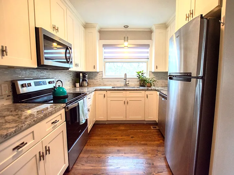 Modern updated kitchen and appliances with a sunny view of your private backyard