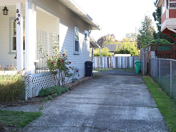 Driveway goes deep, secured by gate.