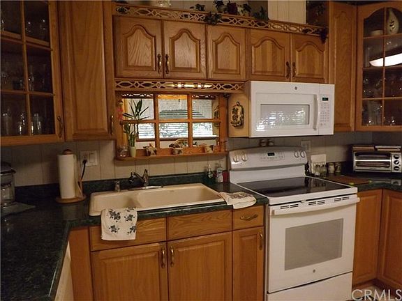 Lighted cabinet with framed mirror over sink.