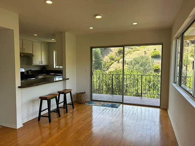 Dining room plus kitchen seating area. Sliding patio door leads to outdoor deck.