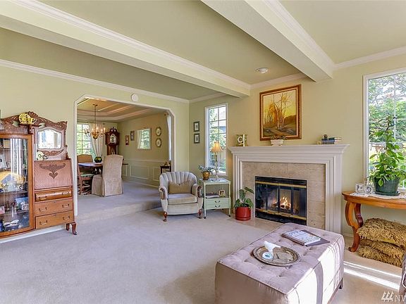 Enter to the spacious formal living room a boxed beams and a cozy wood burning fireplace.