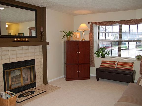 Living room has new carpet, WBFP with ceramic brick surround