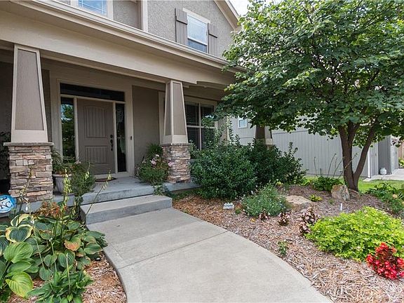 Darling covered front porch to relax on!
