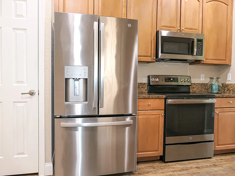 View of Kitchen and new appliances. Door to Pantry
