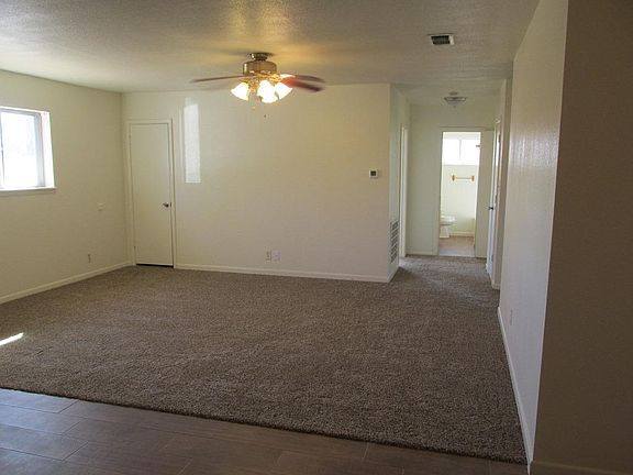 LIVING ROOM LOOKING TOWARDS HALLWAY AND BATHROOM