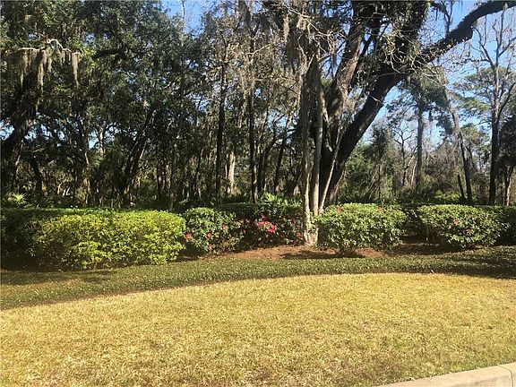 Beautifully landscaped "island of trees" in front of the lot.