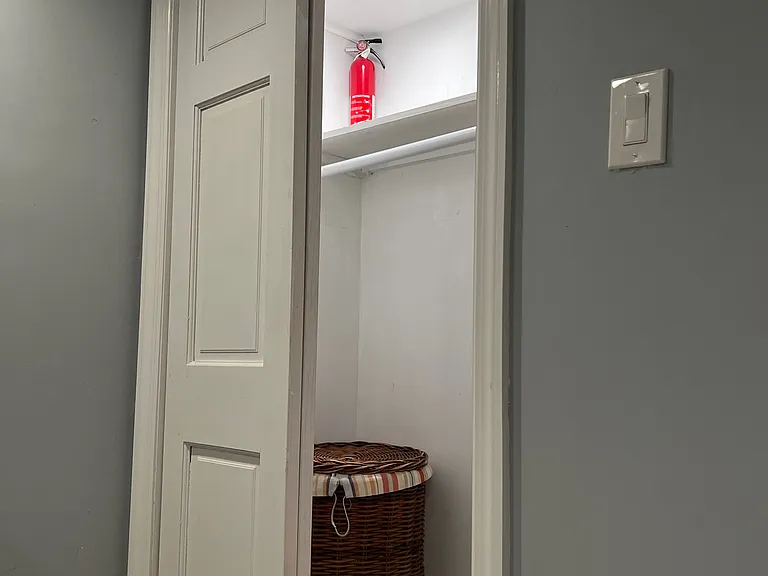 Bedroom closet with hanging bar and shelf.