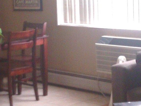 Dining area opens up to living room with a great window looking out towards downtown. wall unit top of the line AC