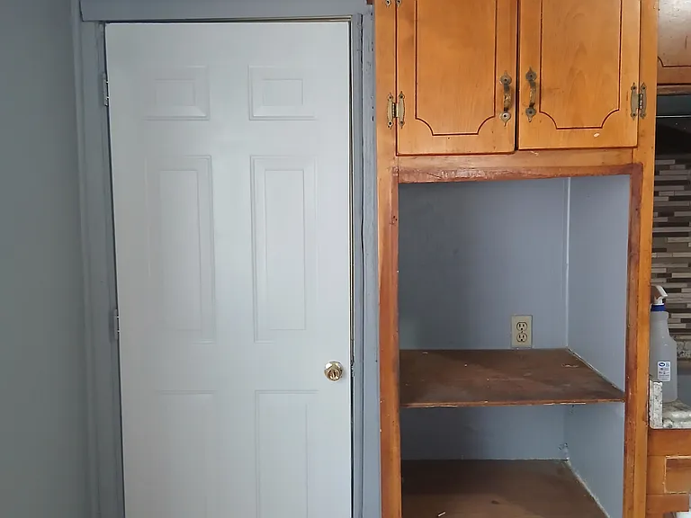 Another view of kitchen and exterior door to garage