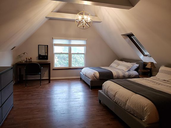 Upstairs master bedroom with two queen size beds in picture