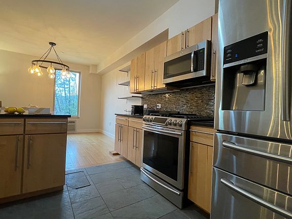 One side of Kitchen - Microwave, Oven, Stove, Fridge. Overlooks Dining Area and picture window.