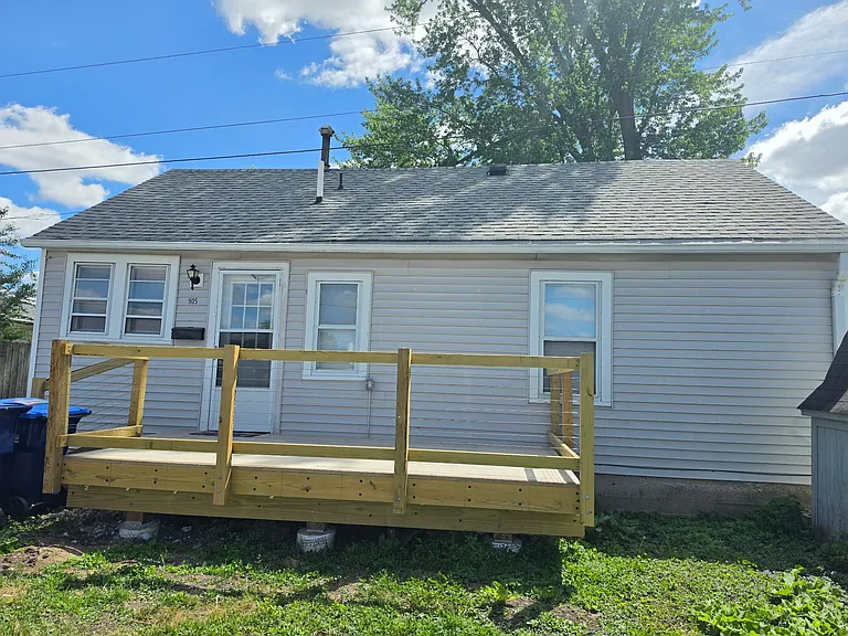 Back of home with porch