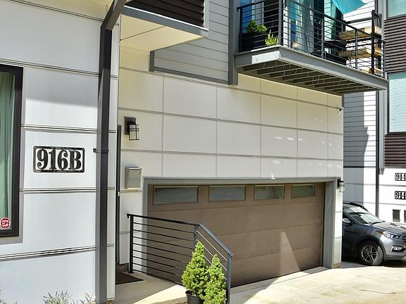 Photo of entrance, private two-car garage, and balcony