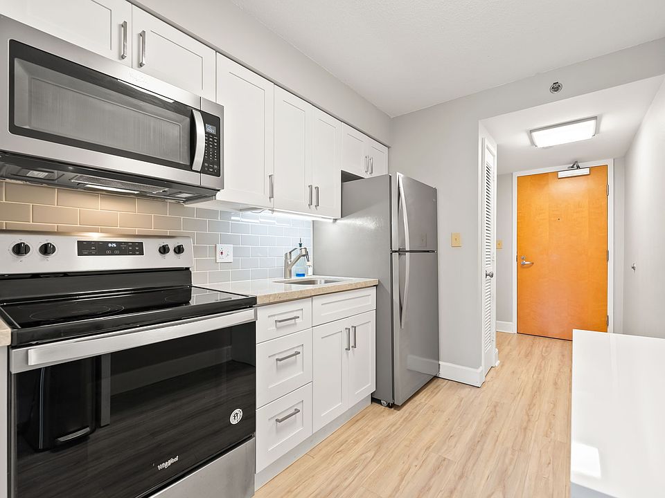 newly renovated kitchen with quartz countertops, tile backsplash, soft close shaker cabinets and stainless steel appliances.