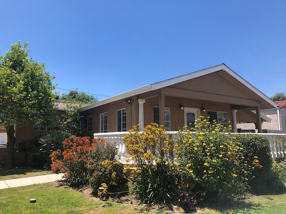 Exterior with Large Front Porch and Lemon Tree!