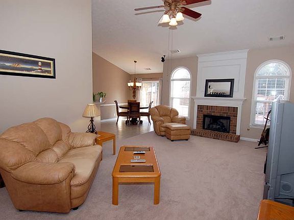 Family rm w/vaulted ceiling, upgraded fan, brick frplce, & open views to ktcn!