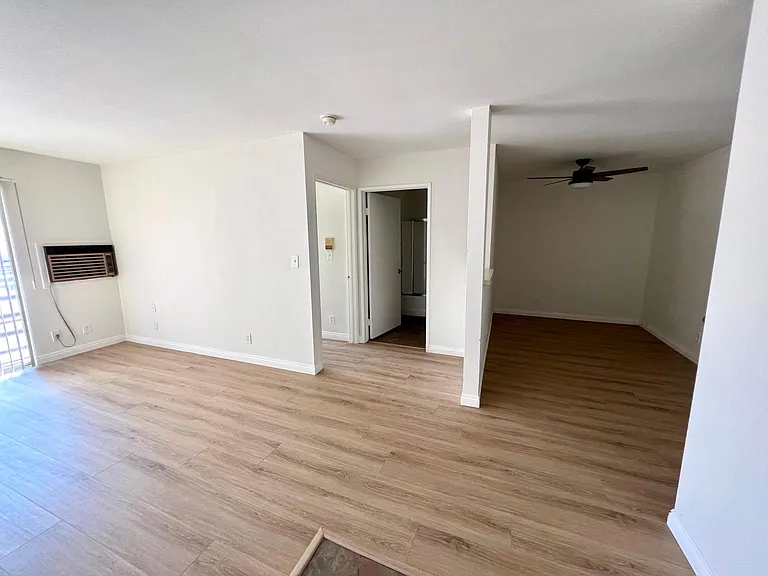 Overview of living room, bedroom door, bathroom door, and entryway room