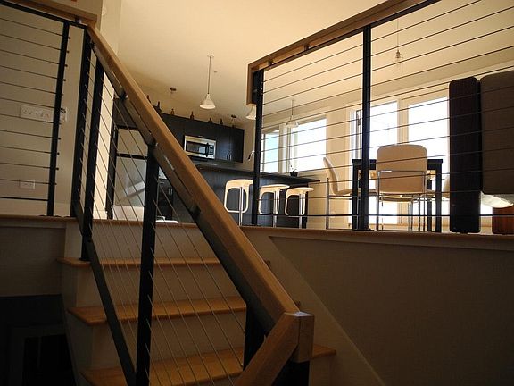 Interior stairs to open fourth floor living/dining space. 