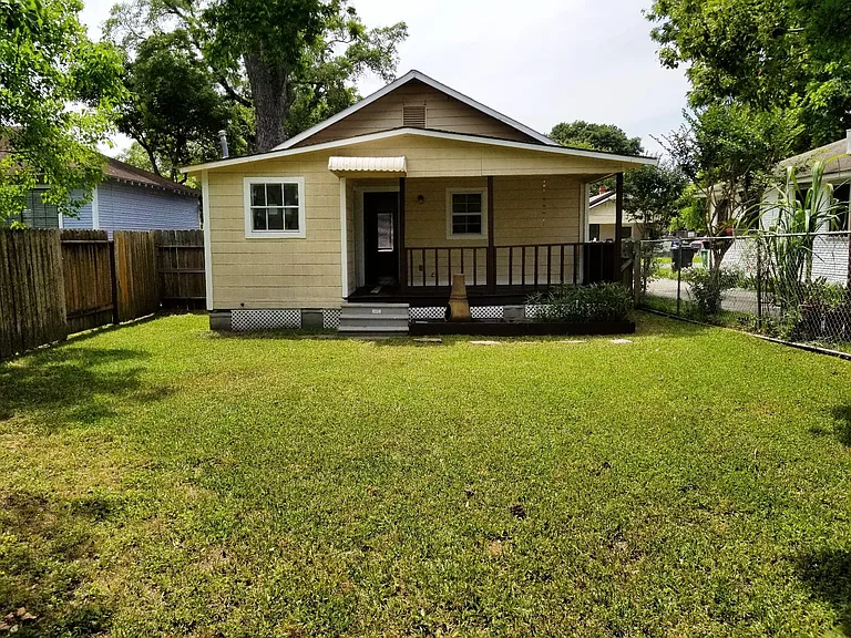 Large back yard, gated and separately gated from the front yard. Back porch is covered and has rails.
