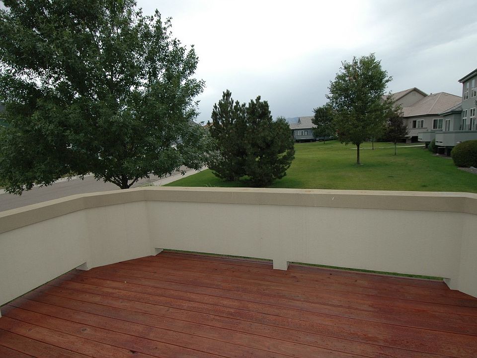 Deck with new stucco and new decking faces park with mountain views