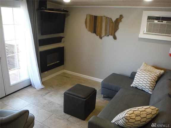 Family room with slider to deck has AC, fireplace, & can be an extra bedroom