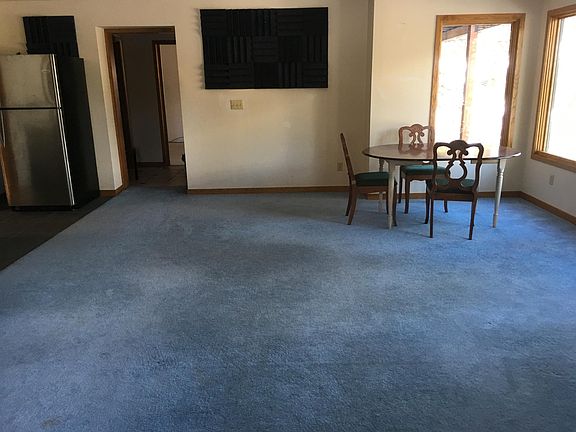 Large Living room looks out to trees & mountians view (Table and chairs not included, shown for perspective)