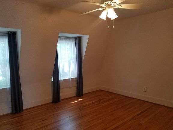 Large upstairs bedroom has ceiling fan and fits a king bed
