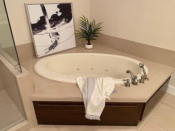 Take a soak in the jacuzzi tub in this luxurious spa bathroom!