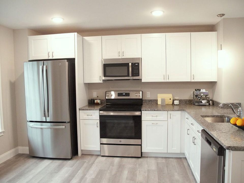 Shaker White Kitchen Cabinets with Granite Counter Tops and French Door Refrigerator