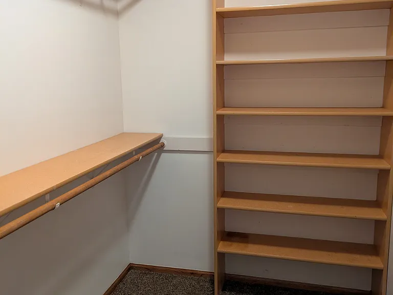 Primary walk-in with lots of shelves. Second bedroom has a smaller walk-in closet.