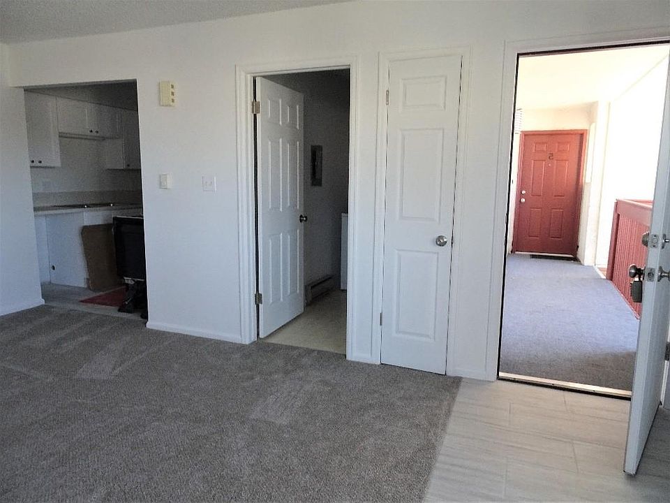 from left to right, kitchen laundry room with a full-sized washer and dryer, entry door.