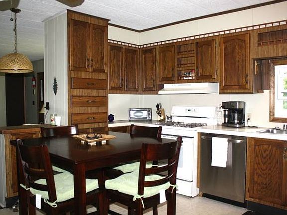 Kitchen features updated cabinets, appliances, and flooring.