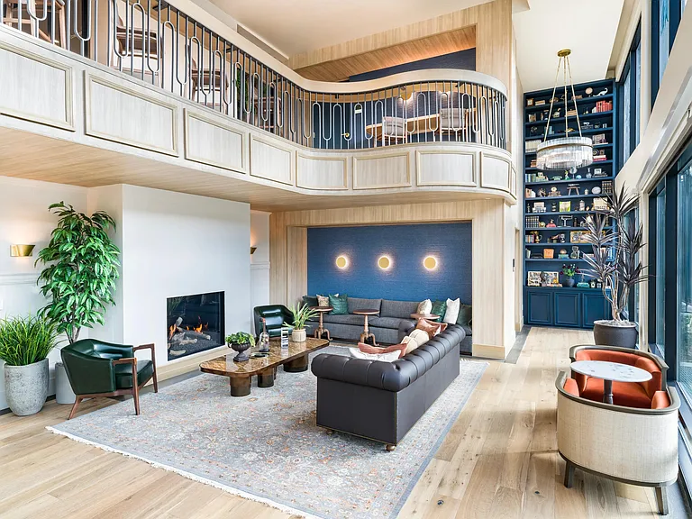 Expansive clubroom with fireplace and lounge seating at Modera University Park.